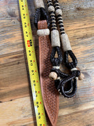 Brown woven leather halter on 55in 10-plait California romal reins with black rope and beige beads