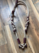 Hand-crafted natural rawhide braided one-ear Western horse headstall with cream and burgundy leather accents