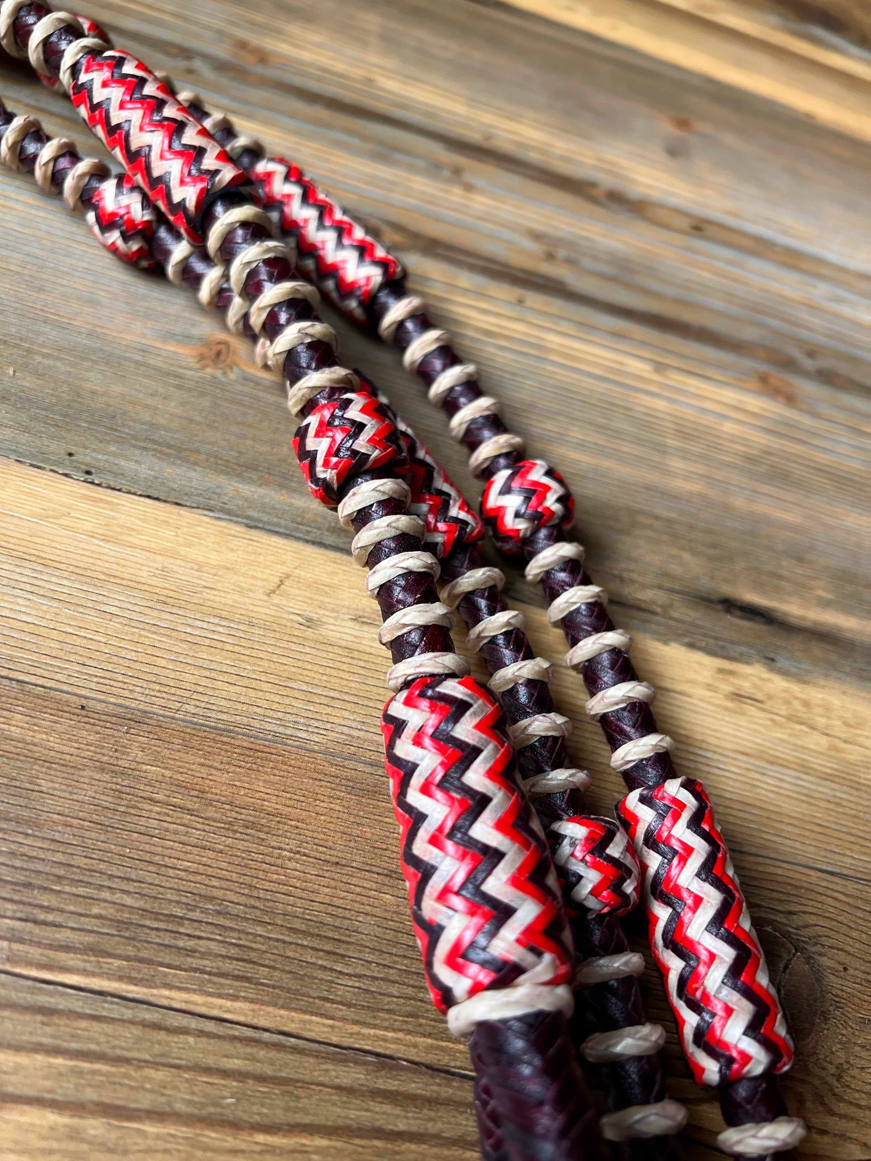 Dark cherry Romal reins with red white black zigzag leather beads on twine
