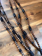 Brown and black braided leather Romal reins with black rawhide textured beads