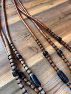 Romal reins with black rawhide: brown black braided leather lanyards beads