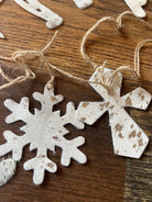 White distressed wooden snowflake cross ornaments with rustic twine hangers