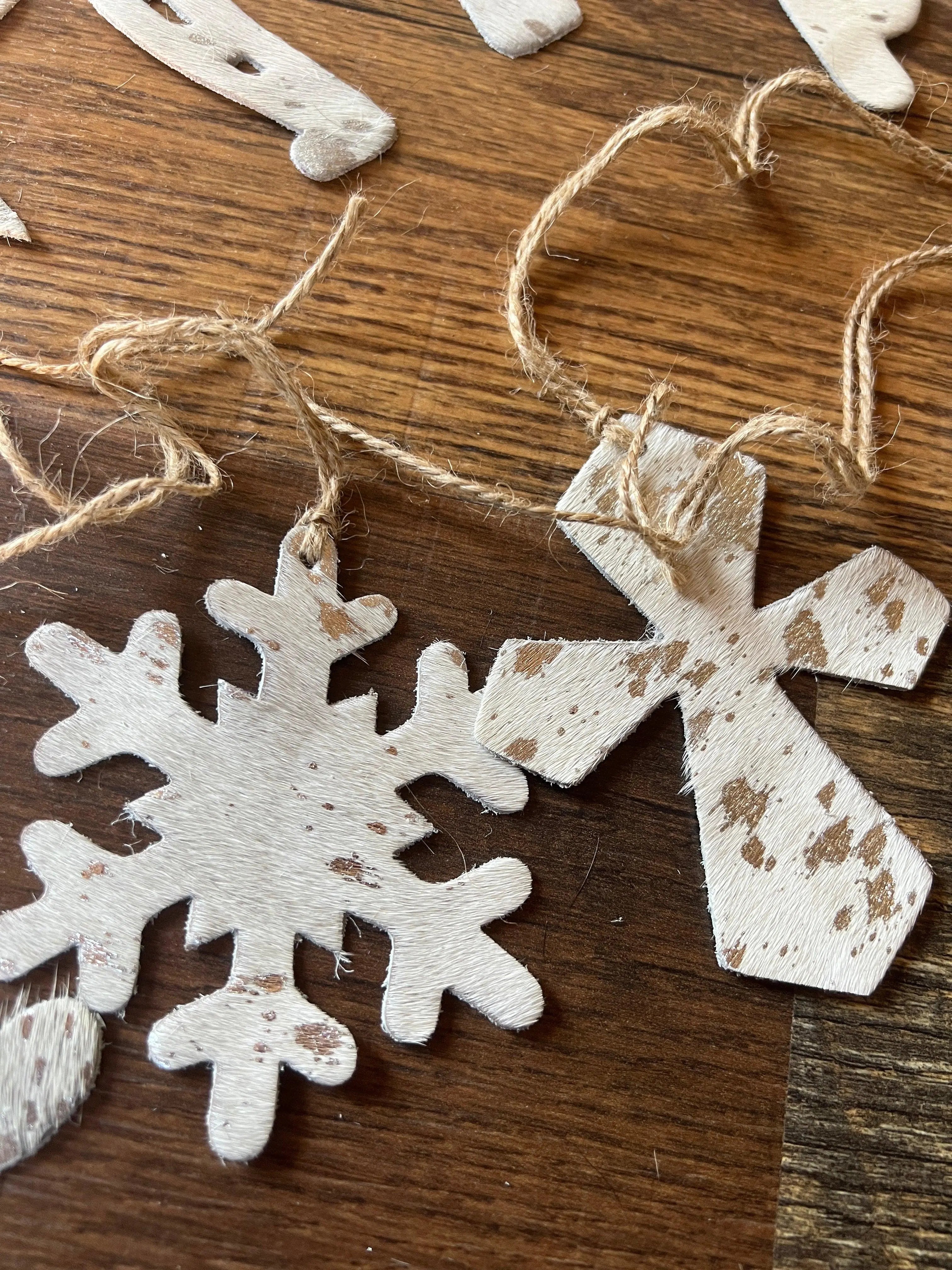 White distressed wooden snowflake cross ornaments with rustic twine hangers