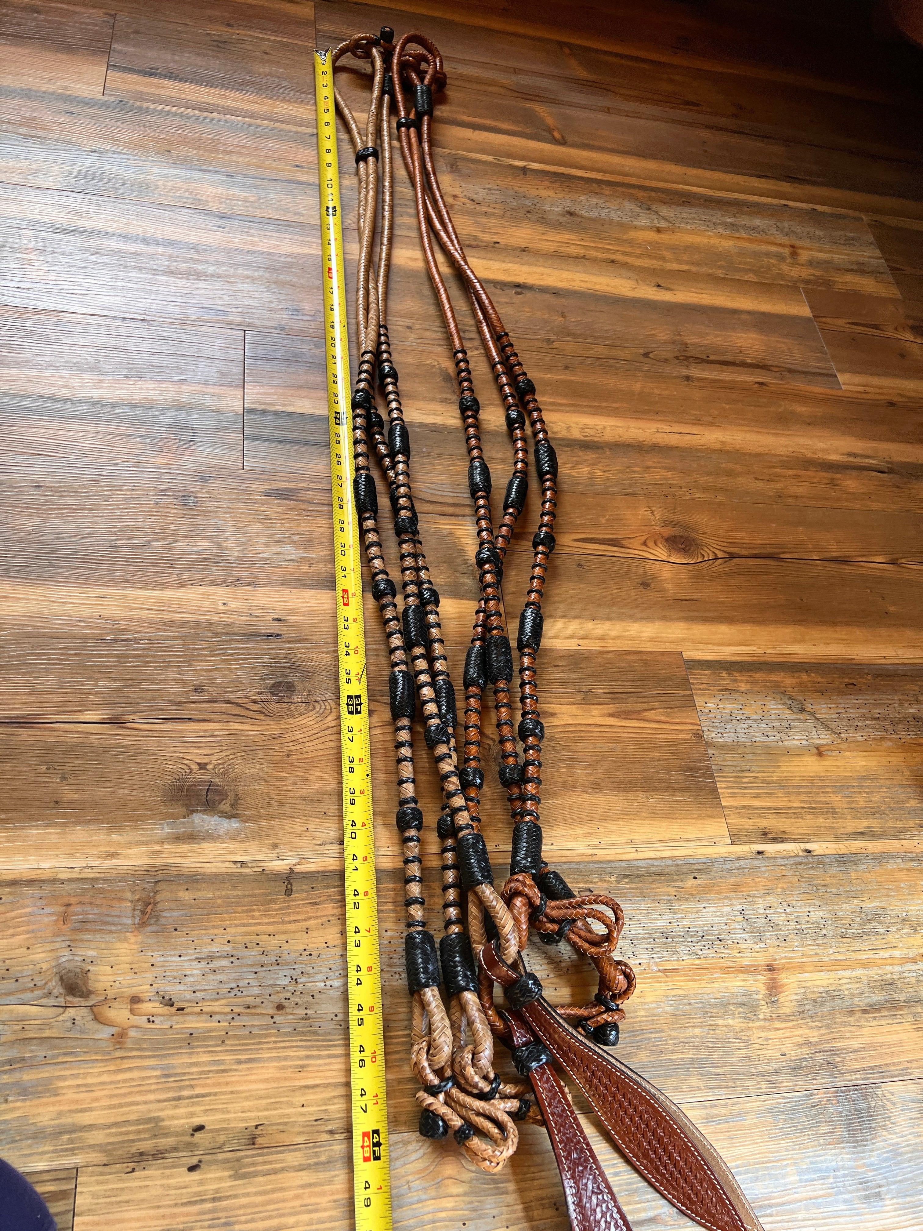 Brown leather Romal reins with black rawhide and tan beaded sections