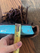 Turquoise brown leather wallet with fringed detailing on Acid Wash Teal saddle bag rear cinch