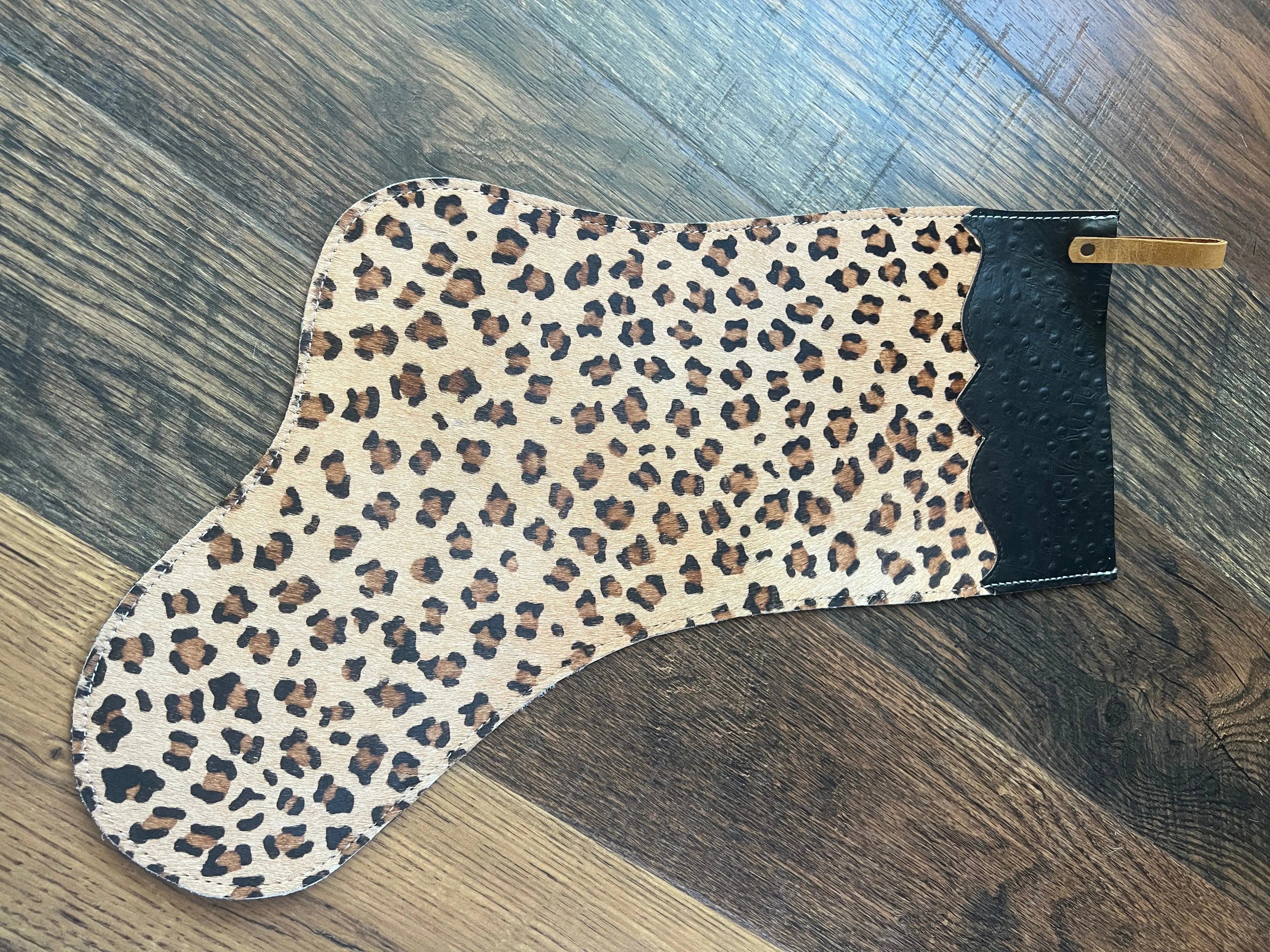 Cheetah cowhide Christmas stocking with leopard-print leather, black scalloped edge, gold zipper