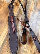 Dark brown leather romal reins strap with red stitching and tassels