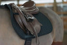 Brown leather saddle with silver hardware on new Benefab black therapeutic pad