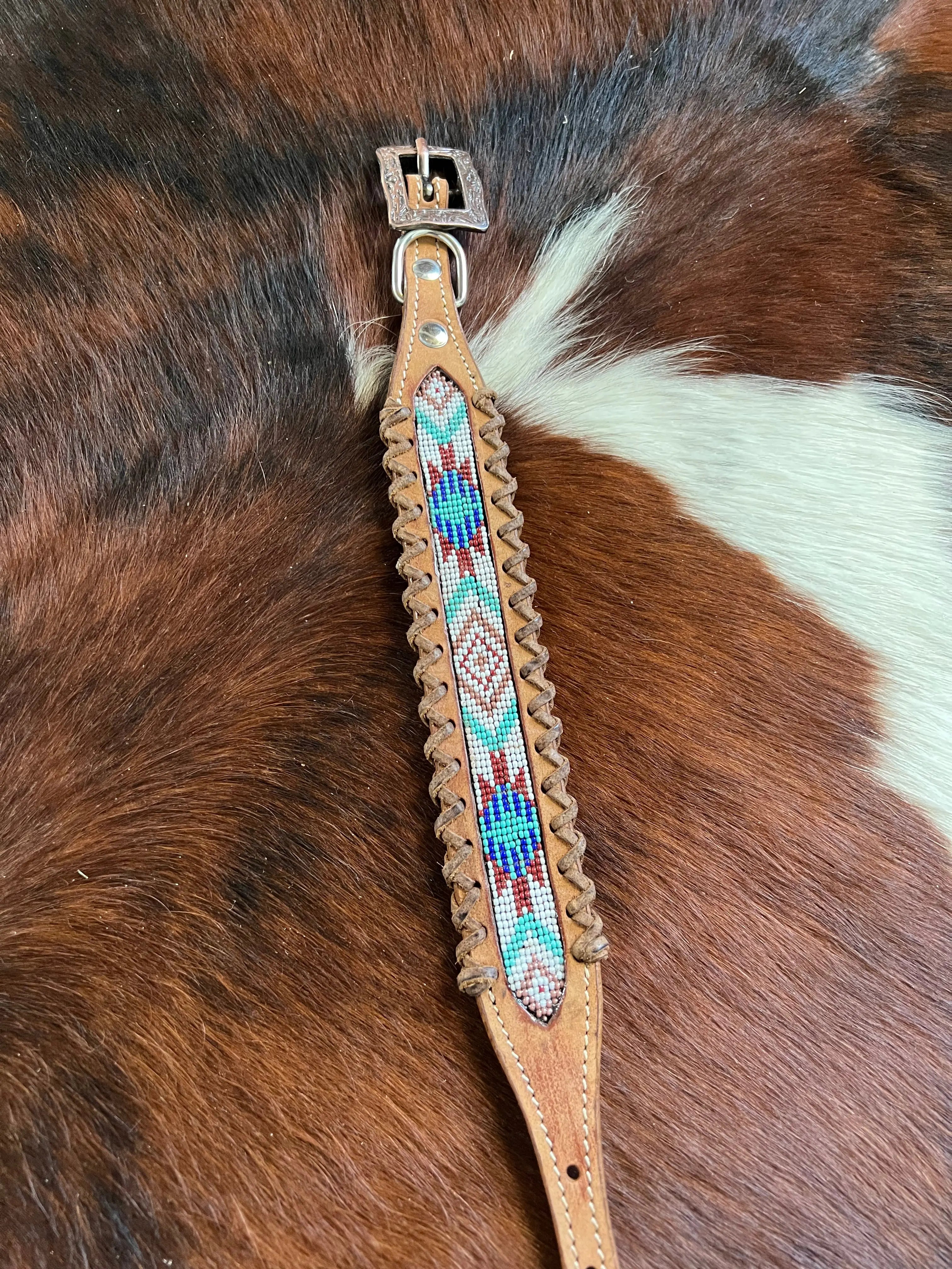 Genuine leather dog collar with white, teal, and burgundy southwest beaded inlay designa leather wrapped edge and copper hardware. Dog