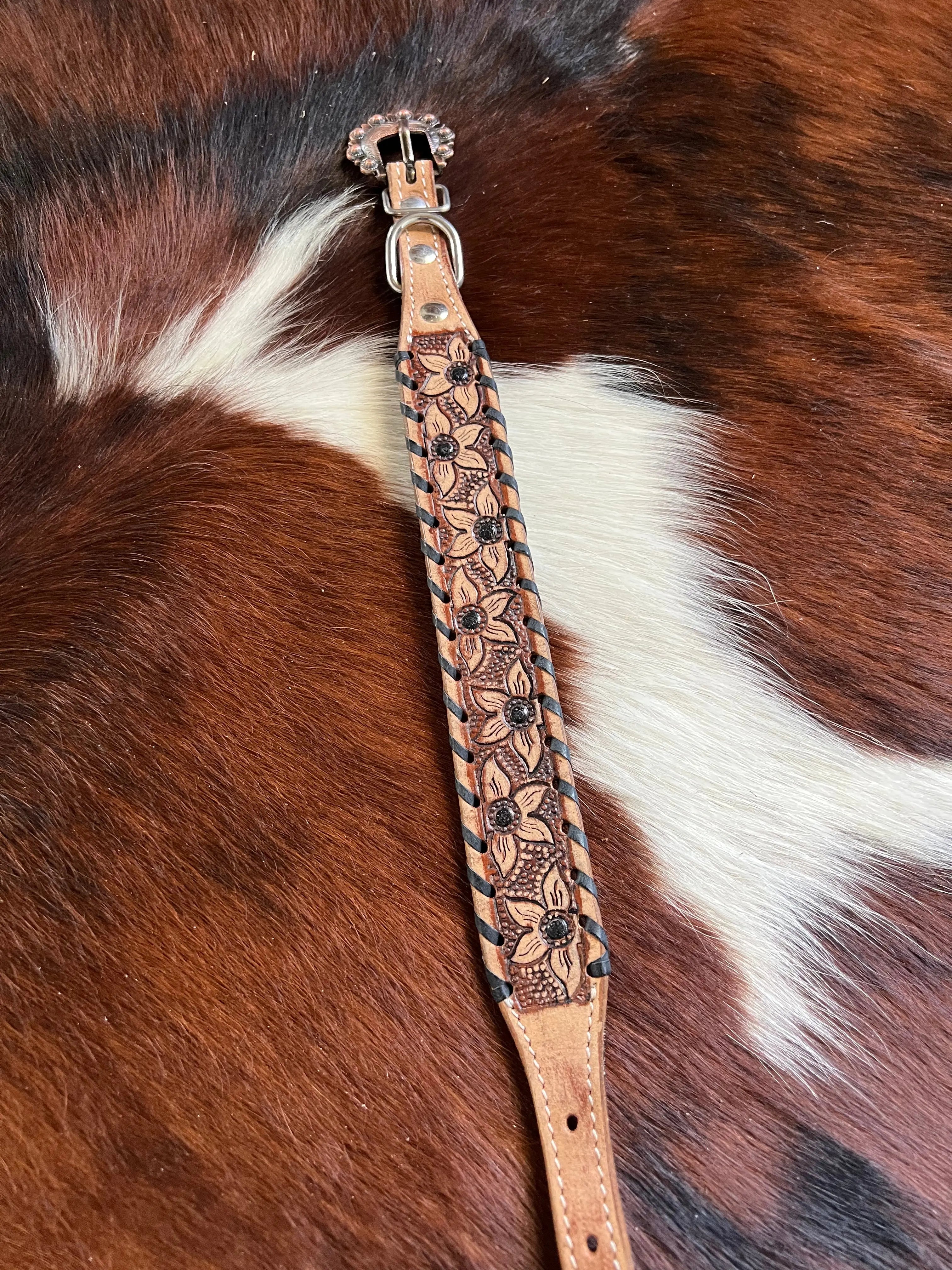 Tan leather bridle strap with floral tooling, black beads, rhinestone buckle