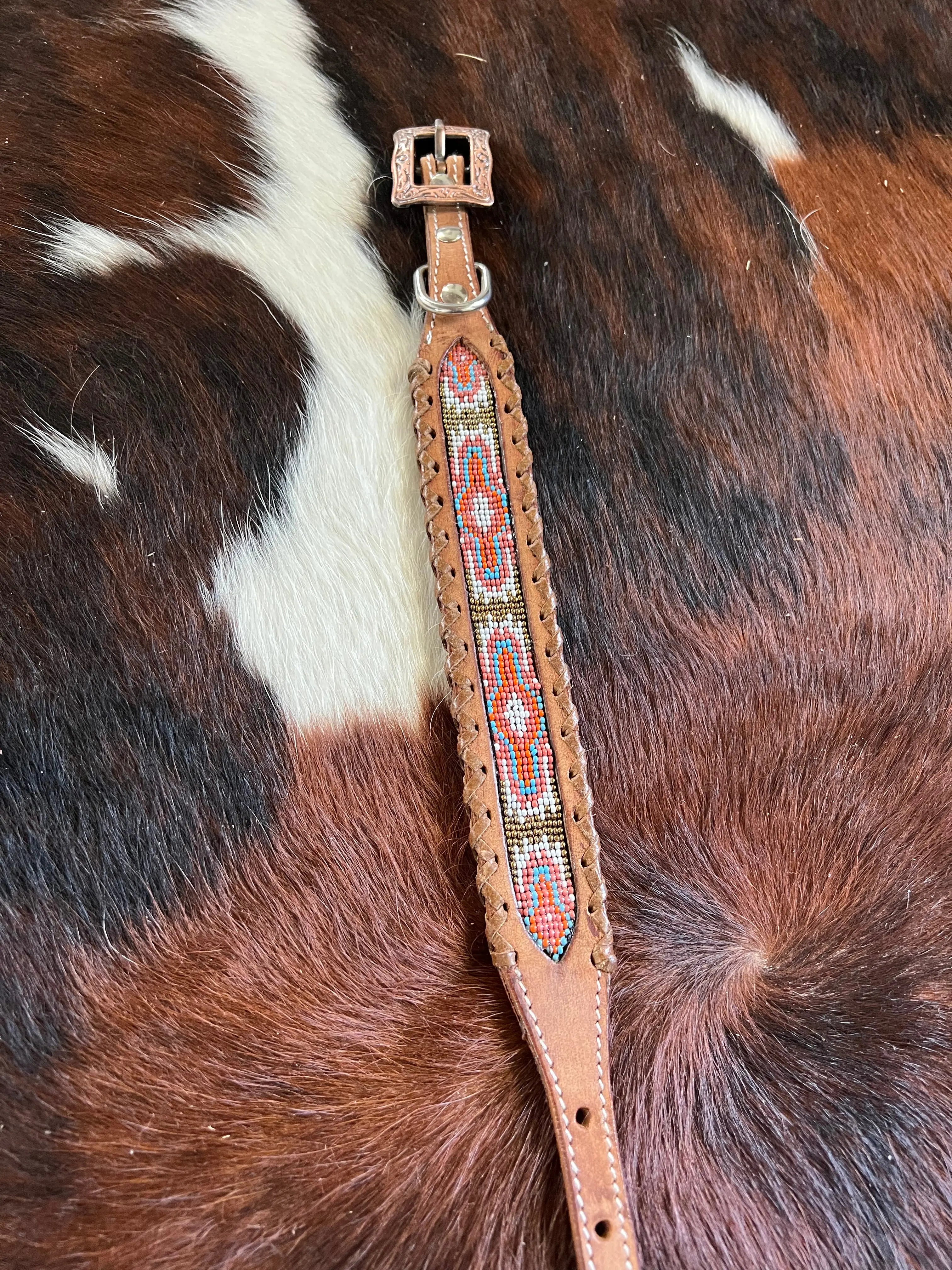 Genuine Leather dog collar with pink, white, and gold southwest beaded inlay design, a leather wrapped edge Dog