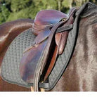 New Benefab therapeutic black saddle pad on brown leather saddle on horse