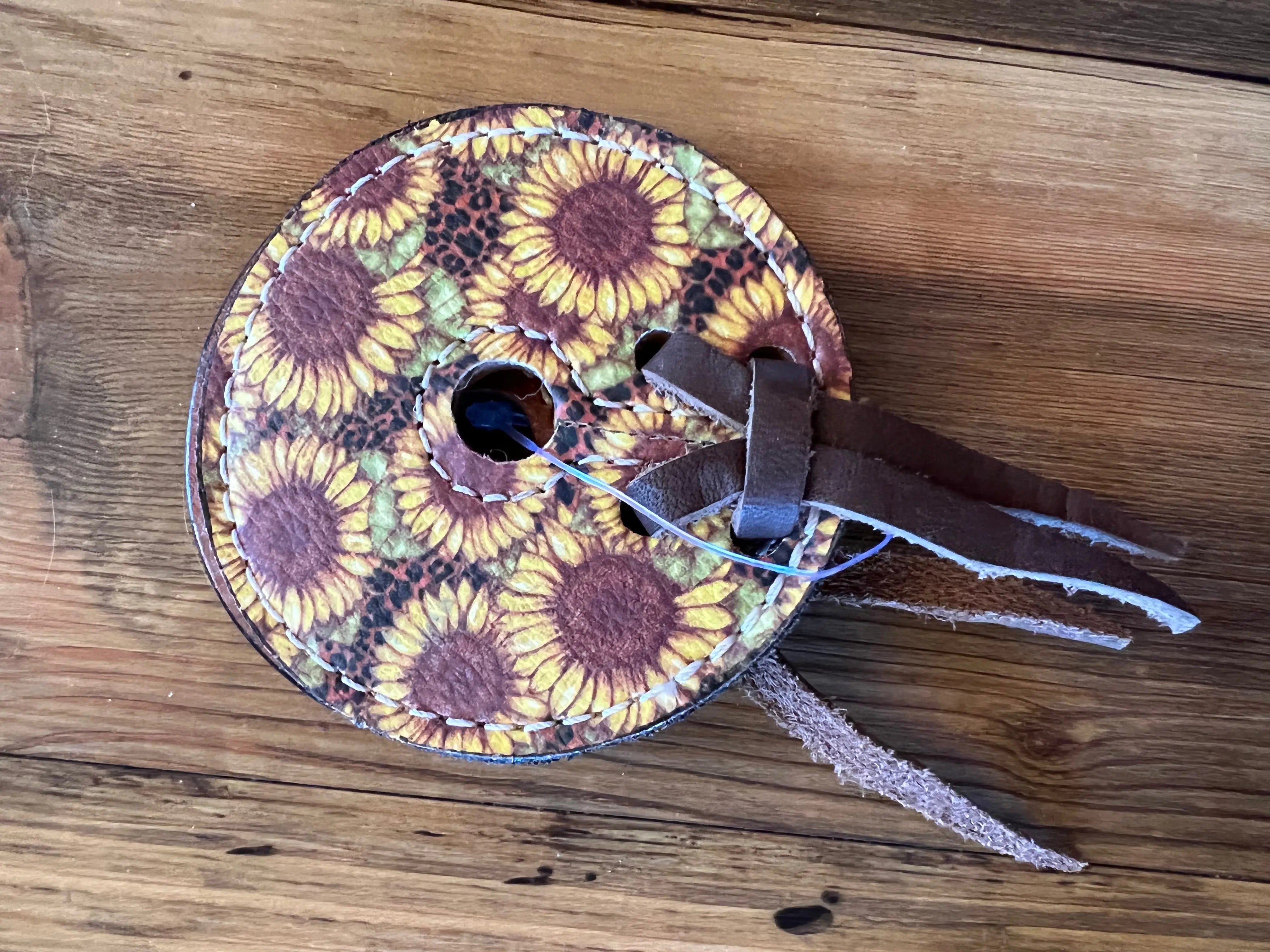 Sunflower Leopard Bit Guards: circular leather spool with sunflower pattern