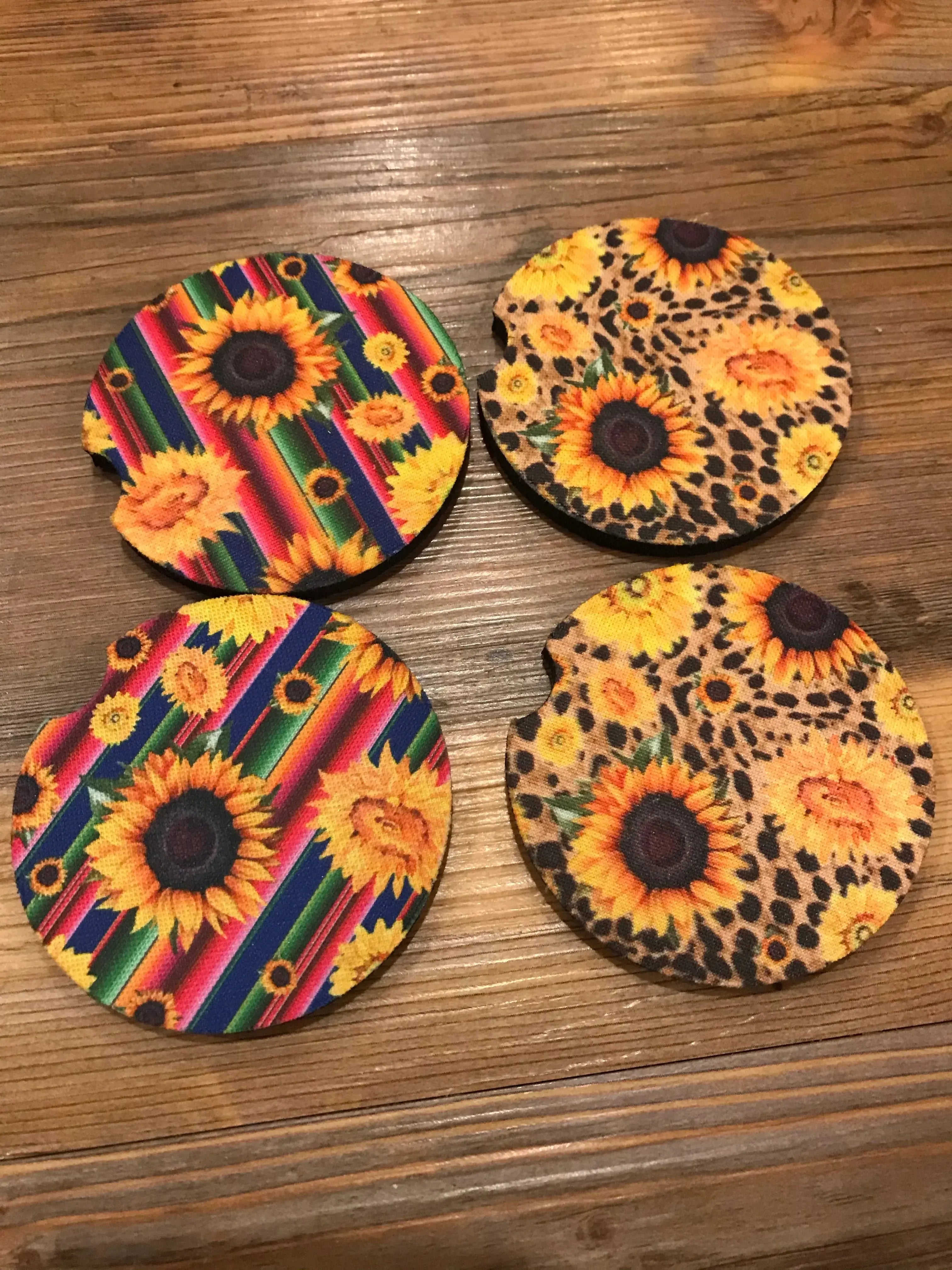 Set of 4 vibrant sunflower car coasters on striped leopard backgrounds