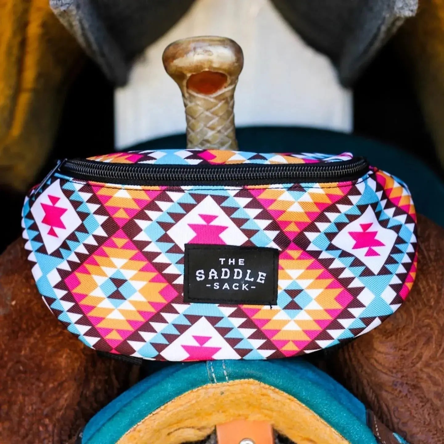 The Saddle Sack with colorful southwestern geometric pattern attached to a horse saddle